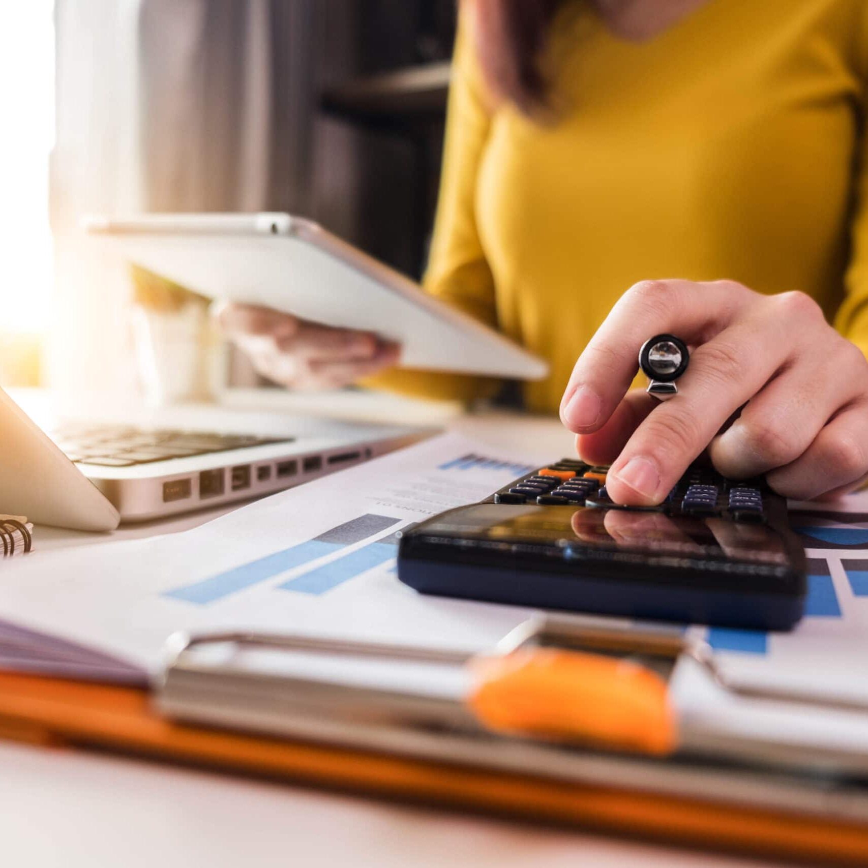 Business  women using calculator with computer laptop, Business accounting, budget and loan paper in office.