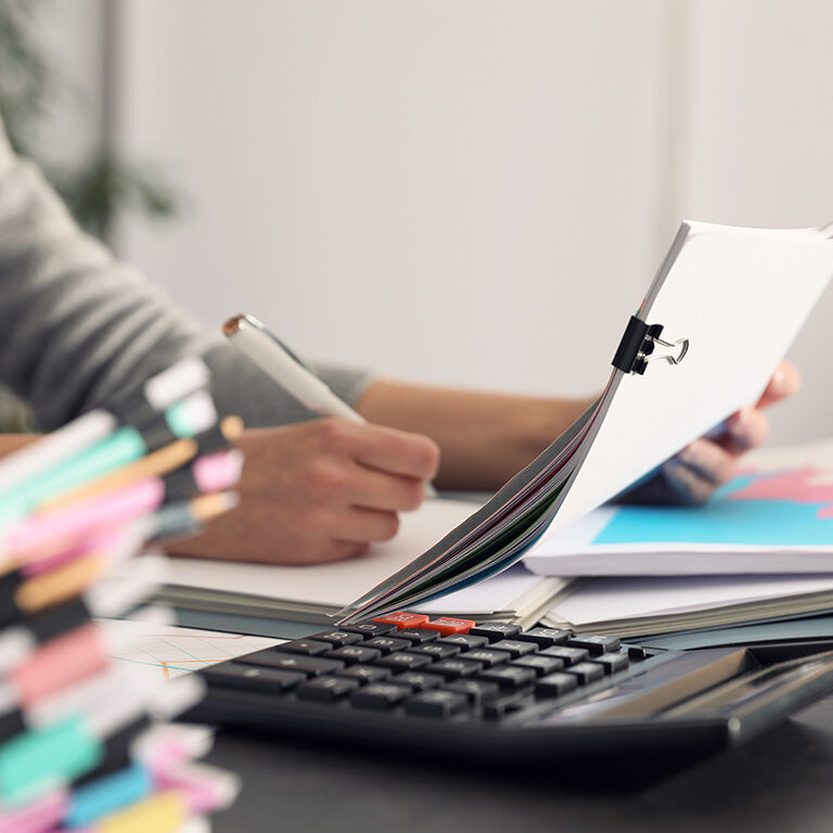 Office employee working with documents at table, closeup